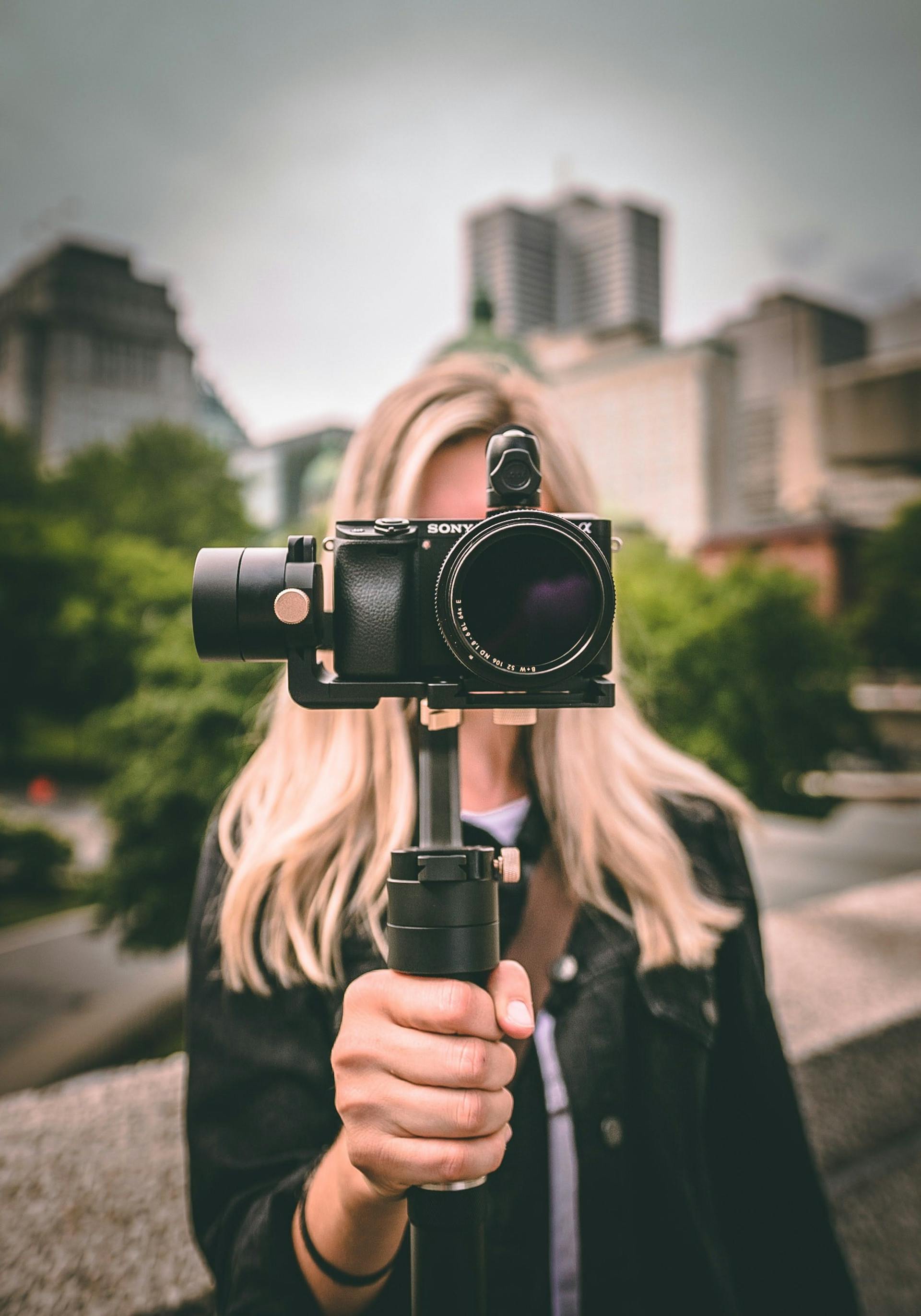 Young woman holding a small video camera